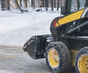 snow cleaning machine work hard in city streets b